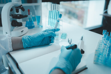 Chemist taking notes on research data, Scientist is working in the laboratory, Chemist is analyzing experimental results and taking notes in the laboratory, lab idea.