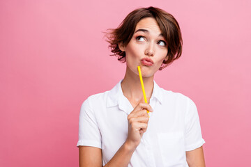 Wall Mural - Portrait of student young girl creative art designer holding pencil to write her ideas minded look mockup isolated on pink color background