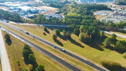 Canvas Print - View from above of busy American highway with fast moving trucks and cars. Interstate transportation concept