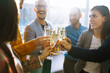 © maxbelchenko - Colleagues in the office celebrate the concluded deal with champagne and sparkling wine. A group of people with glasses of champagne having fun, relaxing in the office. Concept of work, holiday.