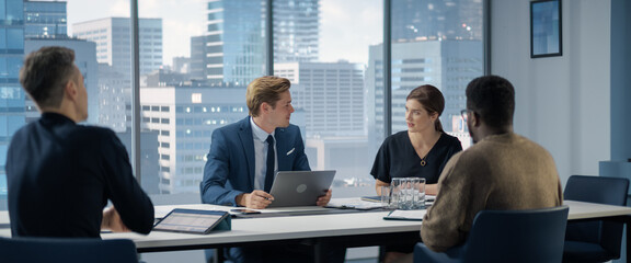 Modern Multi-Ethnic Office Conference Room Meeting: Motivated African American Businessman Presenting Investment Strategy to Partners, Pitching Ideas. Diverse Team of Businesspeople.