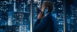 © Gorodenkoff - Backview of Handsome Caucasian Businessman in Stylish Suit Standing Next to Window in Big City Office with Skyscrapers Late At Night. Male CEO Talking On Smartphone With Partners.