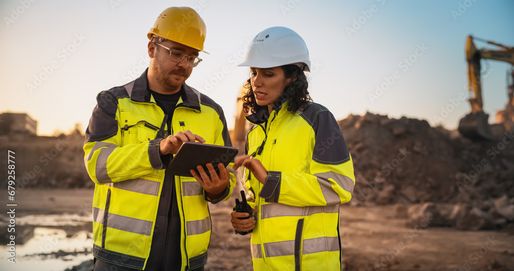 Caucasian Male Civil Engineer Talking To Hispanic Female Inspector And ...