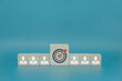 © Winyou - Businessman icon on wooden block and target icon in the middle, teamwork concept to bring success to the goal.