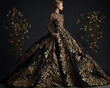 Fashion portrait of a woman in a luxurious long black gown adorned with golden flowers. Perfect for fashion concepts, elegance, luxury.