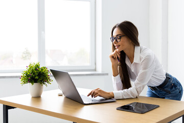 Cheerful and successful woman programmer at work inside modern office, tech support worker with laptop t