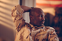 Contemplative Soldier In Camouflage Uniform Taking A Break