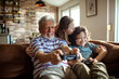 © Marko Geber - Grandfather and Grandkids Sharing a Fun Moment with Video Games