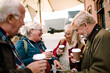 © Davor - Group of elderly friends enjoying coffee together outdoors