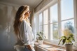 © DigitalMagicVisions - ranquil Moments: Woman's Relaxation by the Windows of Her New Home