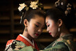 two geisha women wearing traditional japanese costumes on a background of old national interior