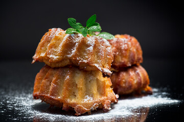 cooked sweet honey muffins in powdered sugar