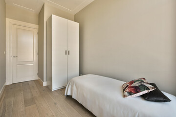 Wall Mural - a bedroom with white walls and hardwood flooring the room is decorated in neutral tones, including light greys