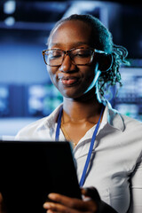 Poster - satisfied admin in data center uses tablet to prevent system electronics overload. efficient expert 
