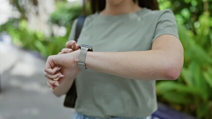 Sticker - Young, beautiful, and confident, a portrait of a smiling hispanic woman enjoying time in her watch at a green city park