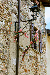 Wall Mural - Beautiful view of the alleys of the historic old town centre in Castellaro Lagusello, Monzambano, Lombardy, Italy. With street lamps decorated with hearts.