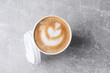 © New Africa - Coffee to go. Paper cup with tasty drink on grey table, top view