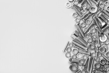 Poster - Different metal bolts and nuts on white background, flat lay. Space for text