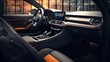 © Abdul - A detailed view of a luxury black car's interior through its open door in a dealership salon, showcasing the high-quality leather seats and advanced dashboard