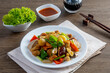 Stir-fried chicken with cashew nuts on a wooden table