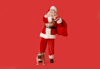 Canvas Print - Santa Claus with bag and French bulldog on red background