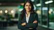 © Farid - Young confident smiling Indian business woman leader, successful entrepreneur, professional company executive ceo manager, wearing suit standing in office with arms crossed. made with generative ai
