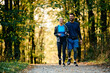 © Drazen - Young happy athletic couple taking a walk in nature.