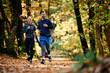 © Drazen - Happy athletic couple jogging through autumn park.