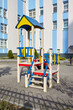Facade of kindergarten building. Colorful playground for childrens on a sunny day