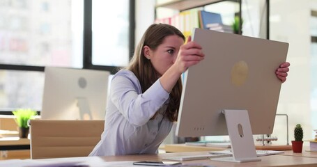 Businesswoman screams hysterically and cracks computer monitor in office
