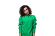 young secretary brunette woman with curly hair dressed in a green shirt