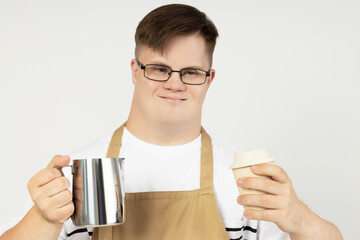 Wall Mural - A boy with down syndrome as a barista in an apron and with coffee