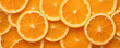Orange sliced background. Oranges cut on orange table.