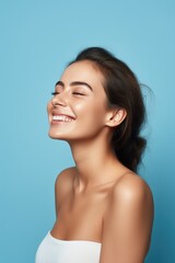 Wall Mural - smiling woman enjoying beauty treatment on blue background. AI Generated