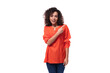 © Ivan Traimak - young pretty brunette woman dressed in orange shirt points her finger