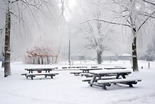 Picnic Benches Covered In Light Snow
