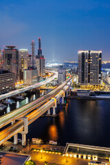 Wall Mural - Kobe skyline from above with port and elevated road portrait format at twilight in Japan