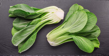 Fresh Bok Choy Or Chinese Cabbage On Slate Stone Cutting Board. Top View.