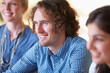 © Marine Gastineau/peopleimages.com - Smile, meeting and young businessman in the office planning a creative project with team of colleagues. Happy, discussion and professional male designer working in collaboration in modern workplace.