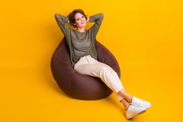 Poster - Photo of lovely cute girl enjoying relax rest hold hands behind head isolated on yellow color background