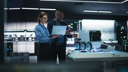 Poster - Portrait of a Team of Two Engineers Collaborating on Developing a Robot for Deliveries in a Manufacturing Facility. Colleagues Analysing Data Using Laptop Computer and Brainstorming for a Project