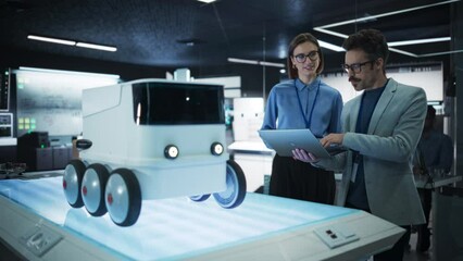 Fototapete - Portrait of Two Colleagues Working in a Research Facility, Using Laptop Computer to Develop a Futuristic Robot for Autonomous Deliveries. Manufacturing Specialist Doing a Demonstration to Team Manager