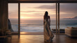 Young woman in an elegant dress in a modern living room overlooking the ocean. Concept of relaxation, enjoyment or freedom.