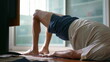© Marco - Senior man taking care of his lower back in morning exercise routine to relieve back pain. Elderly caucasian 70s person doing bridge position, spine health in old age