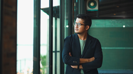 Handsome 38 years old gentle asian  man, wearing glasses, formal slick hairstyle,  in a modern office building beside a huge window