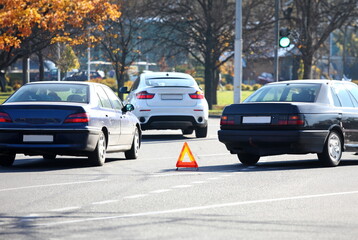 Traffic jam and symbol of forbidden movement on part of street. Automobile in slow motion. Transports driving straight. Warning of danger for drivers