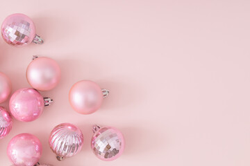 creative trendy layout made of pink christmas baubles on pastel pink background. new year party back