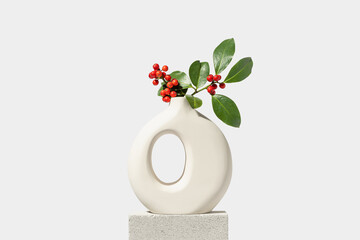 Wall Mural - christmas holly with red berries in white vase. winter natural decoration