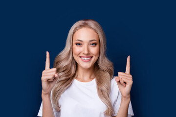 Poster - Photo of gorgeous cheerful girl in trendy clothes two arms direct empty space isolated on dark blue color background