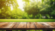© Swaroop - Wooden table and blurred green nature garden background.